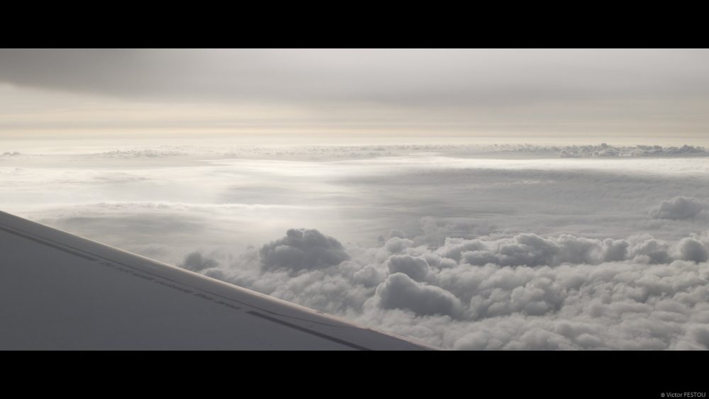 View from the airplane seat, golden clouds at dusk ungraded